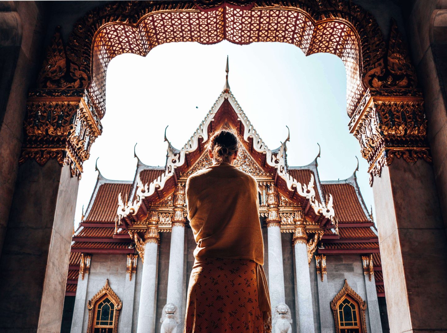 Picture of girl silhouetted against temple in Bangkok