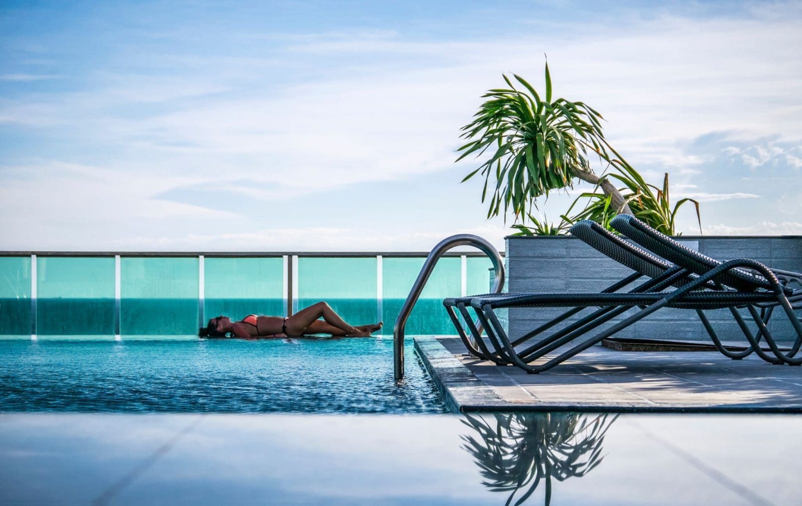 Picture of woman lying by hotel pool