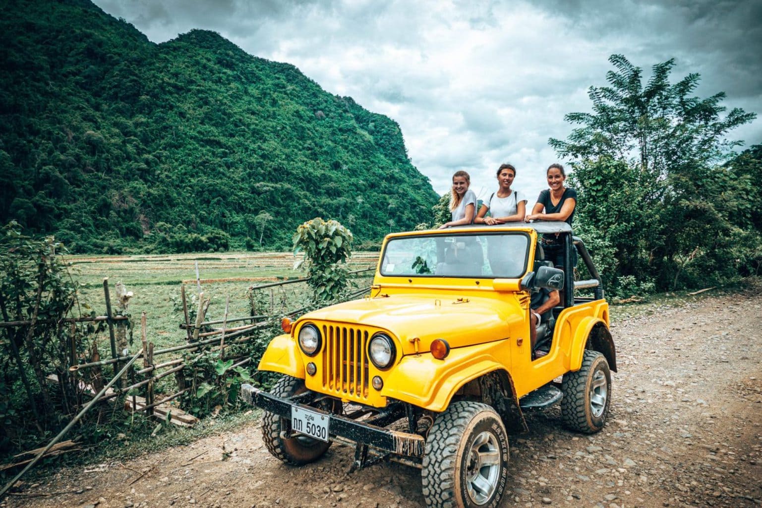 Picture of girls in yellow jeep going to Vang Vieng viewpointLaos